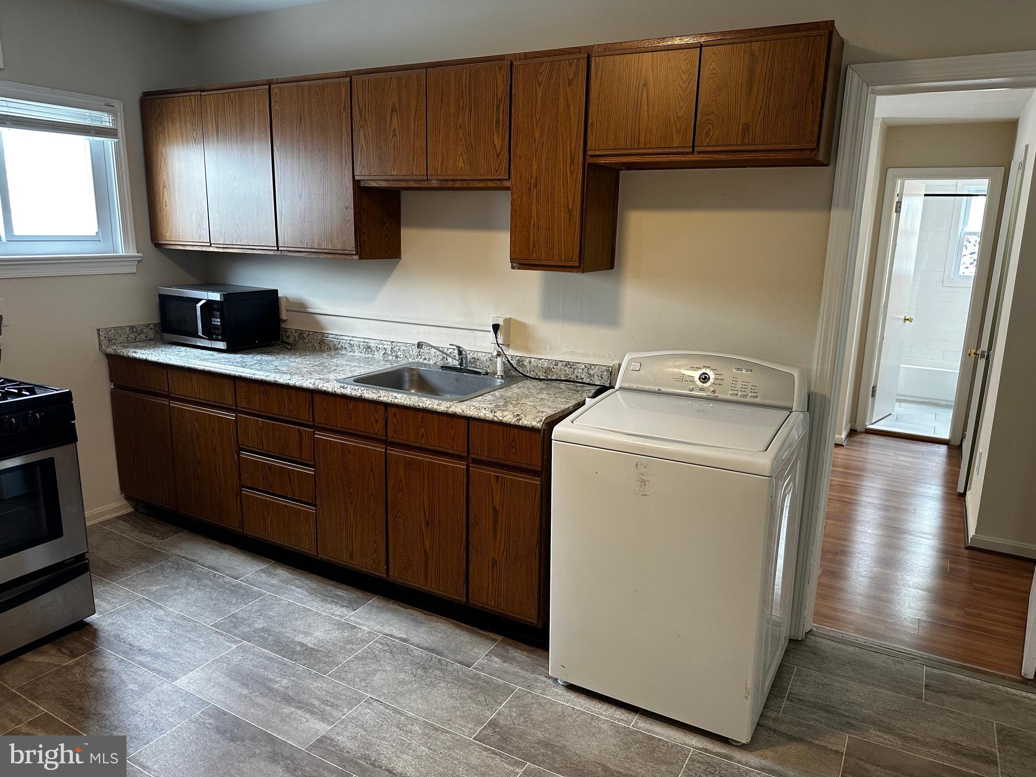 214 10th Street Laurel, MD 20707 - Photo 89 of 118 a utility room with sink dryer and washer