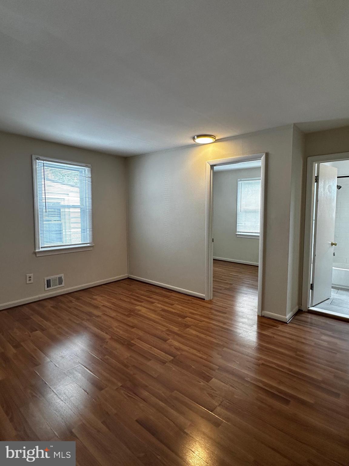 214 10th Street Laurel, MD 20707 - Photo 91 of 118 an empty room with wooden floor and windows