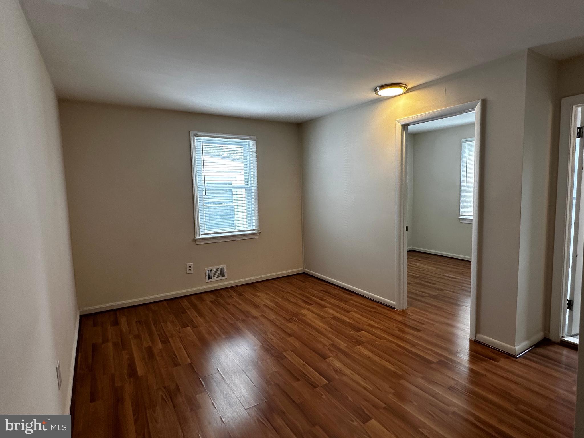 214 10th Street Laurel, MD 20707 - Photo 92 of 118 an empty room with wooden floor and windows
