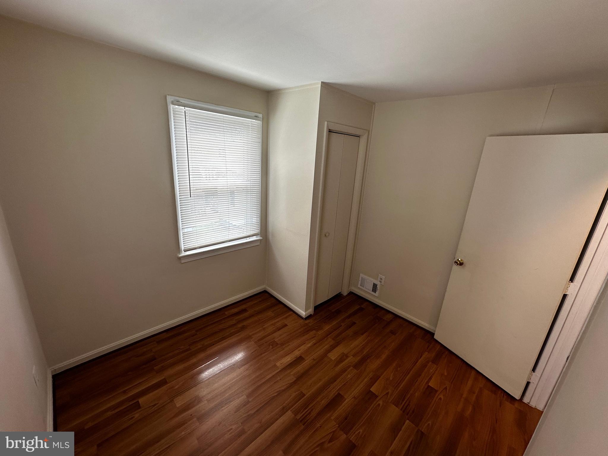 214 10th Street Laurel, MD 20707 - Photo 96 of 118 a view of an empty room with wooden floor and a window