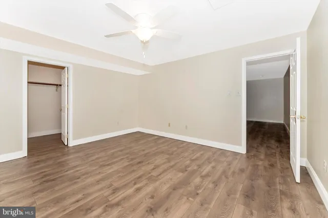 an empty room with wooden floor and closet