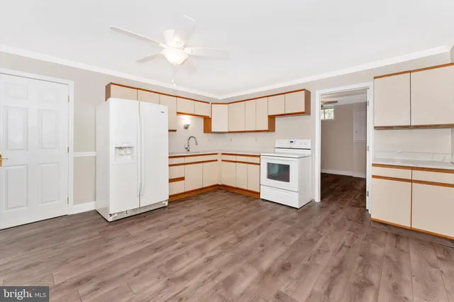 a view of kitchen with wooden floor and electronic appliances