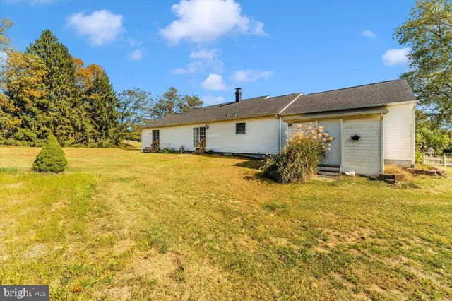 a yellow house with swimming pool in front of it