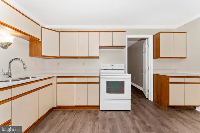 a kitchen with a refrigerator sink and cabinets
