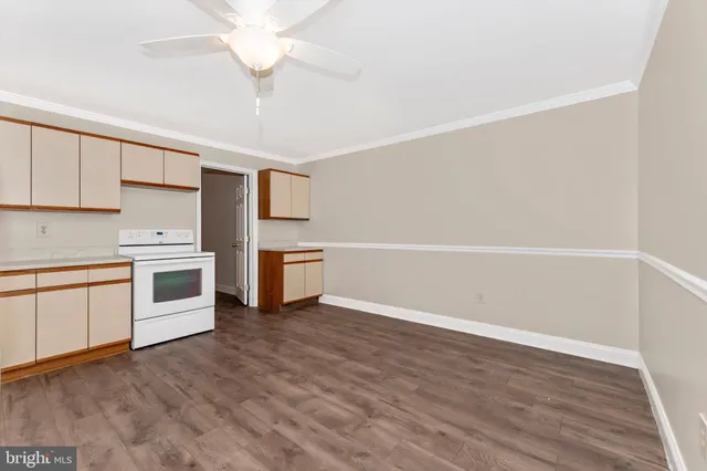 a view of a kitchen with wooden floor and a kitchen space