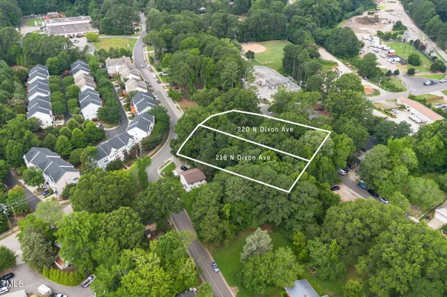 an aerial view of lake and houses with outdoor space