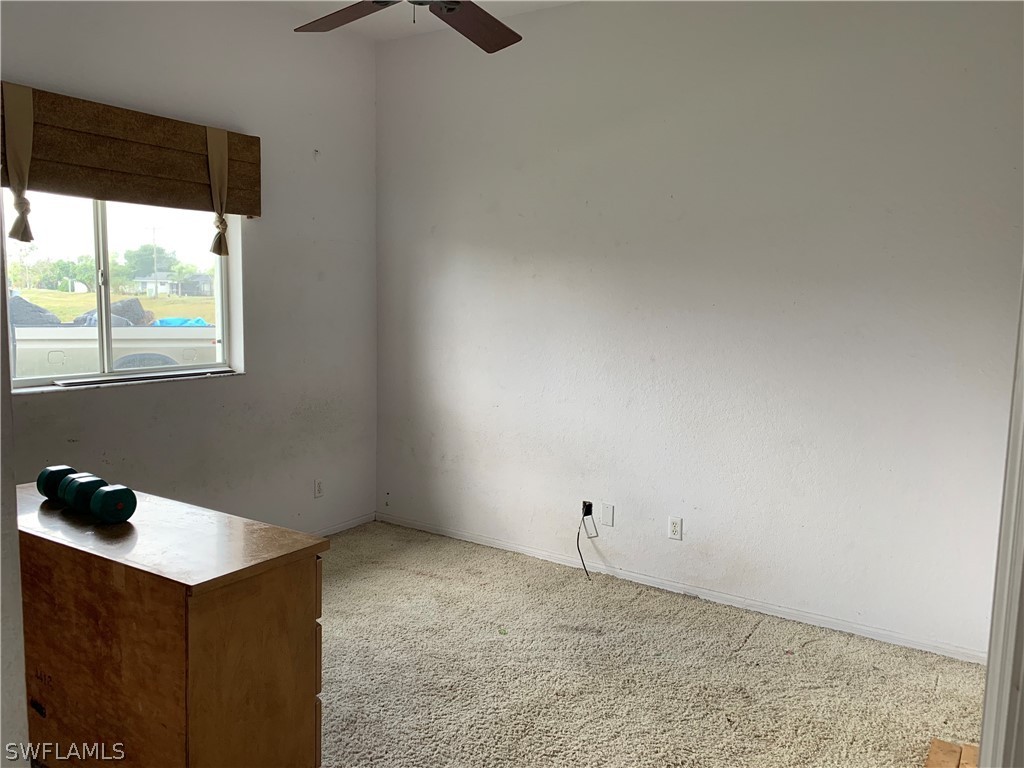 212 Danby Road Lehigh Acres, FL 33936 - Photo 11 of 21 a view of an empty room and a window