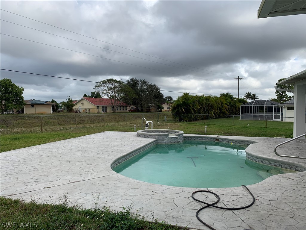 212 Danby Road Lehigh Acres, FL 33936 - Photo 13 of 21 a view of a swimming pool and a yard