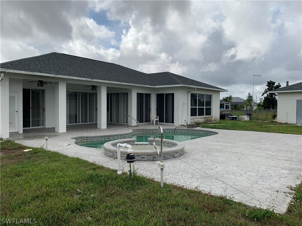 212 Danby Road Lehigh Acres, FL 33936 - Photo 14 of 21 a backyard of a house with table and chairs