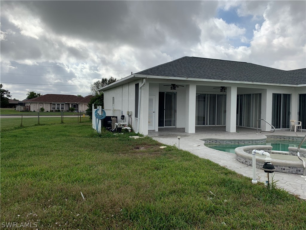 212 Danby Road Lehigh Acres, FL 33936 - Photo 15 of 21 a backyard of a house with table and chairs
