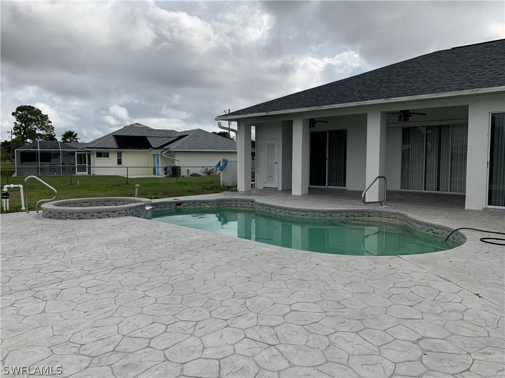 212 Danby Road Lehigh Acres, FL 33936 - Photo 18 of 21 a view of house with a yard and potted plants