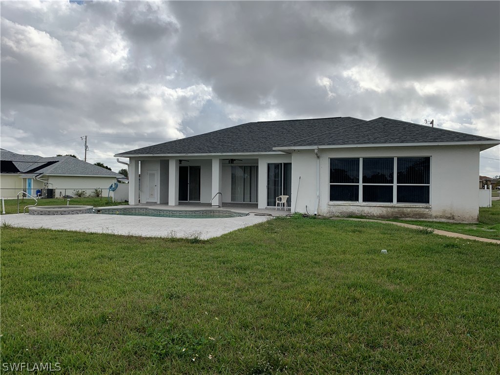 212 Danby Road Lehigh Acres, FL 33936 - Photo 19 of 21 a view of a house with a backyard