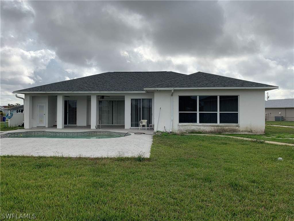 212 Danby Road Lehigh Acres, FL 33936 - Photo 20 of 21 front view of a house with a garden