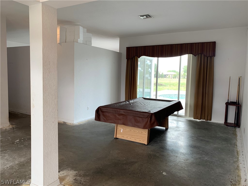 212 Danby Road Lehigh Acres, FL 33936 - Photo 3 of 21 a room with pool table and a window