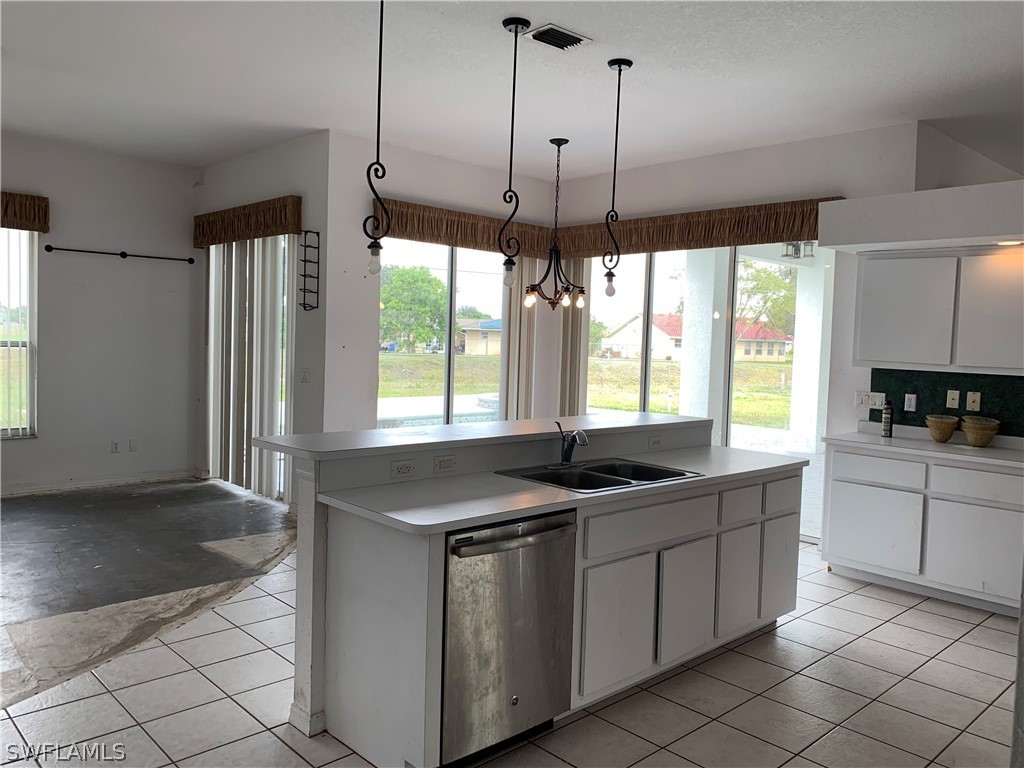 212 Danby Road Lehigh Acres, FL 33936 - Photo 9 of 21 a kitchen with a sink stove and refrigerator