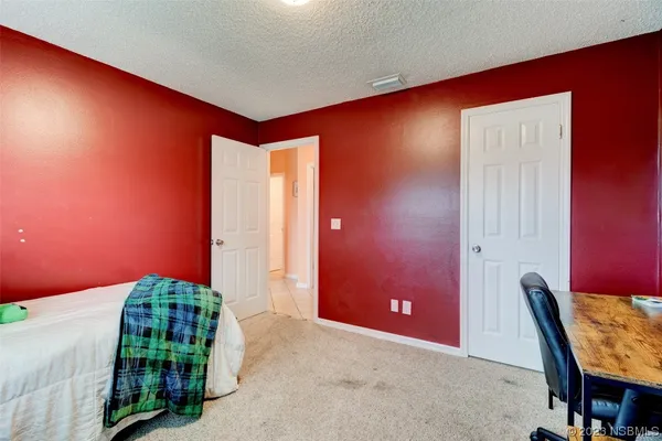 a bedroom with furniture and a large window