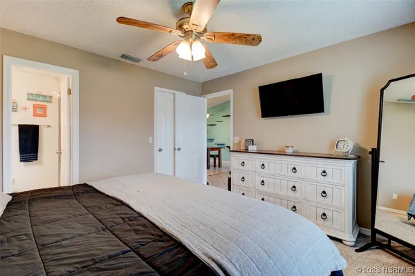 a bedroom with a large bed and a flat screen tv