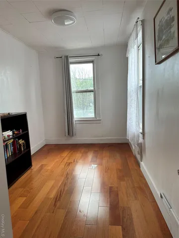 a room with stainless steel appliances kitchen island granite countertop furniture and a refrigerator