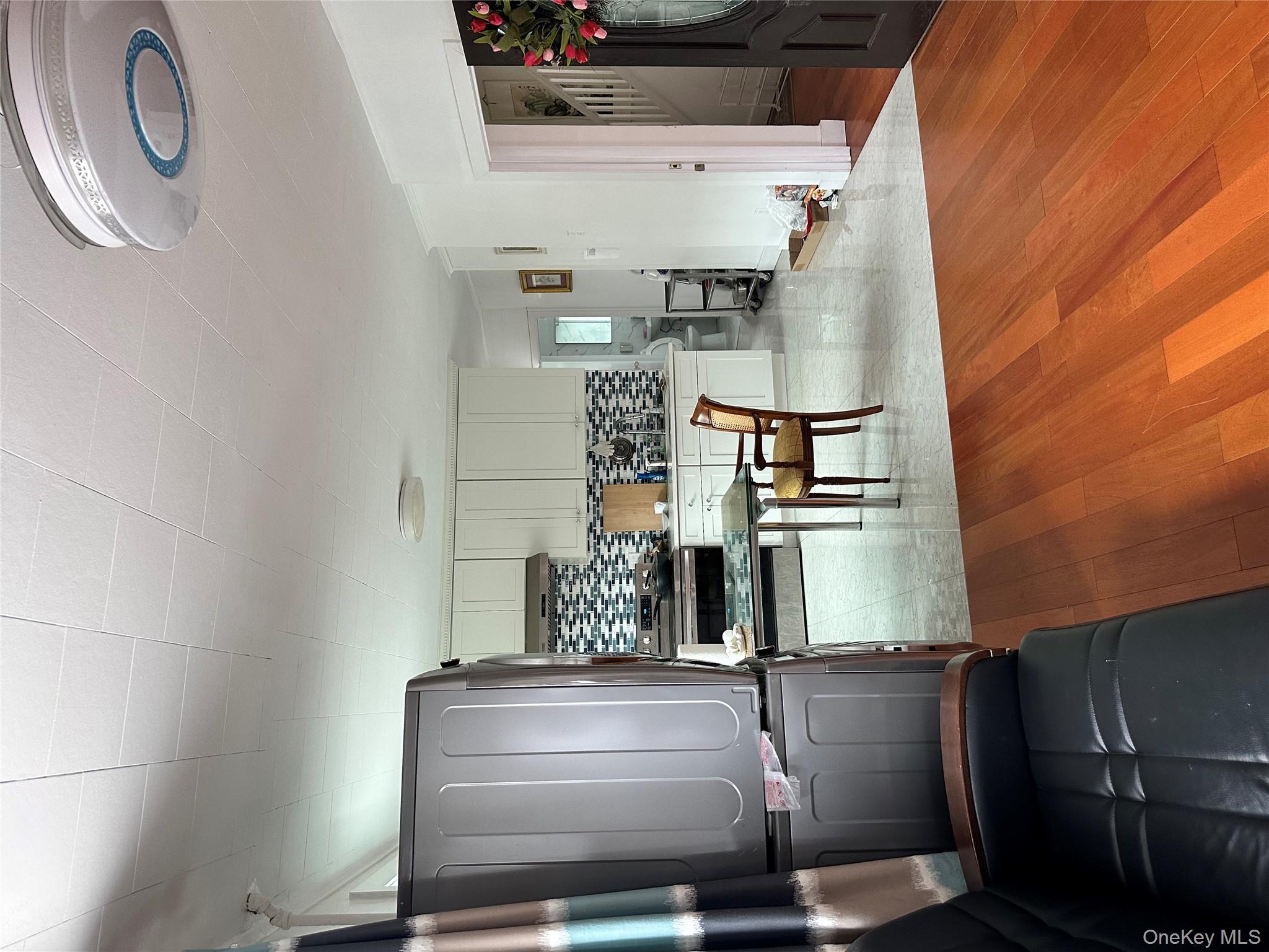 77-02 164th Street, Unit 2 Queens, NY 11366 - Photo 12 of 17 a room with stainless steel appliances kitchen island granite countertop furniture and a refrigerator