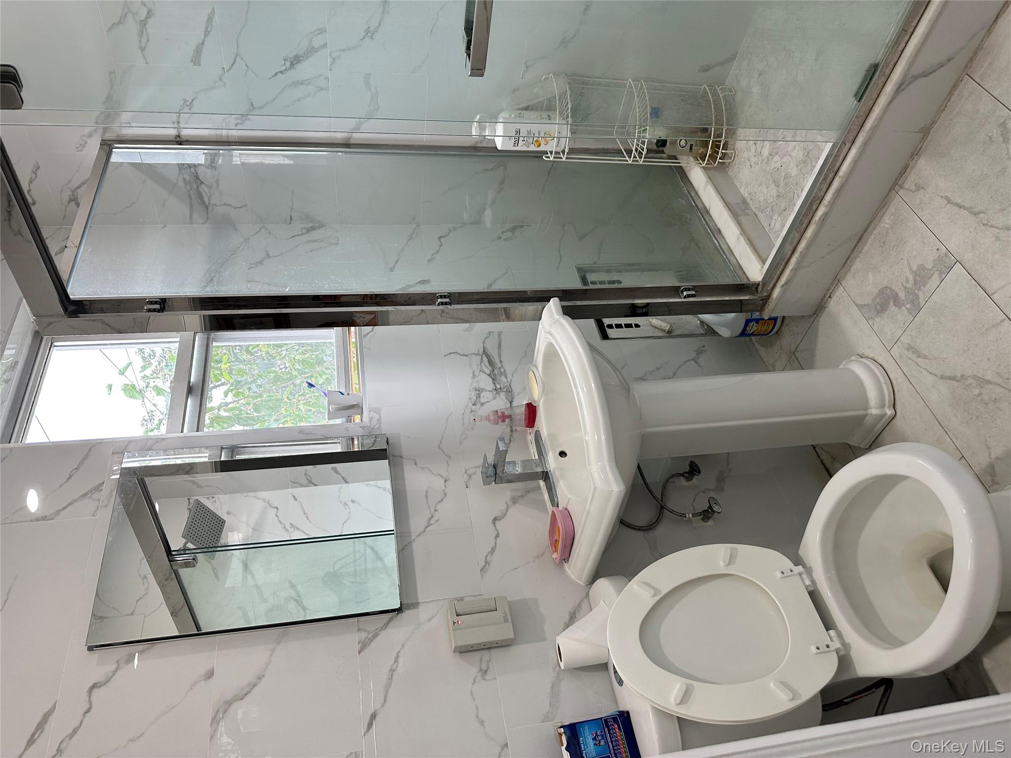 77-02 164th Street, Unit 2 Queens, NY 11366 - Photo 16 of 17 a bathroom with a sink toilet and mirror