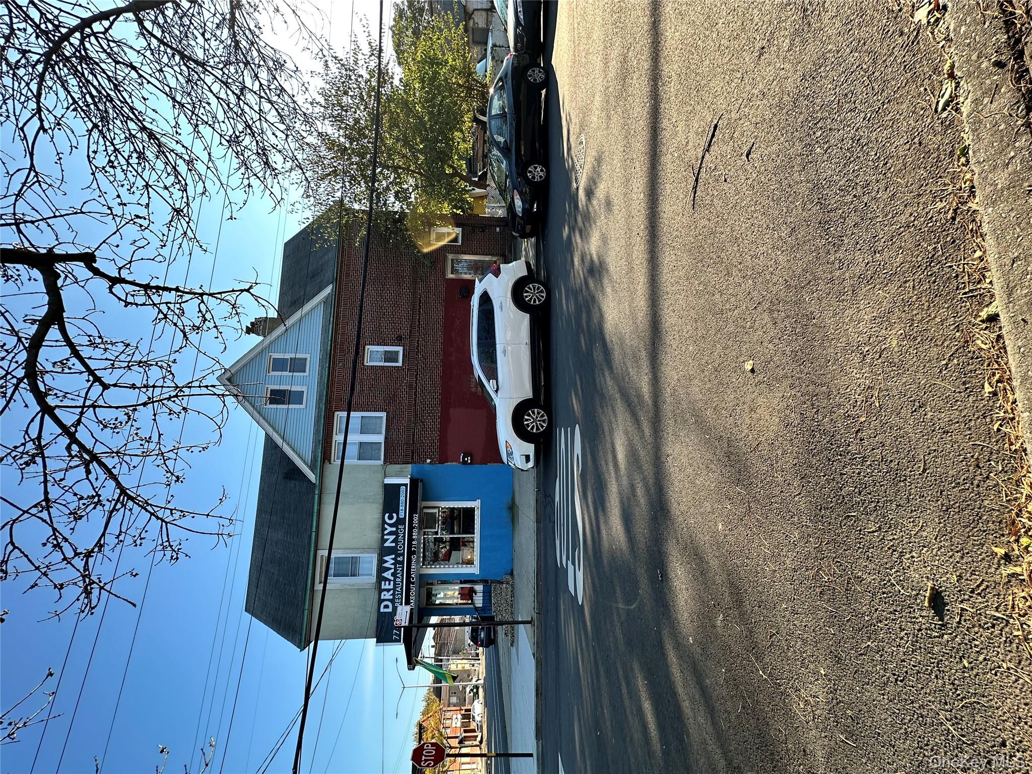 77-02 164th Street, Unit 2 Queens, NY 11366 - Photo 3 of 17 a front view of a house with a yard
