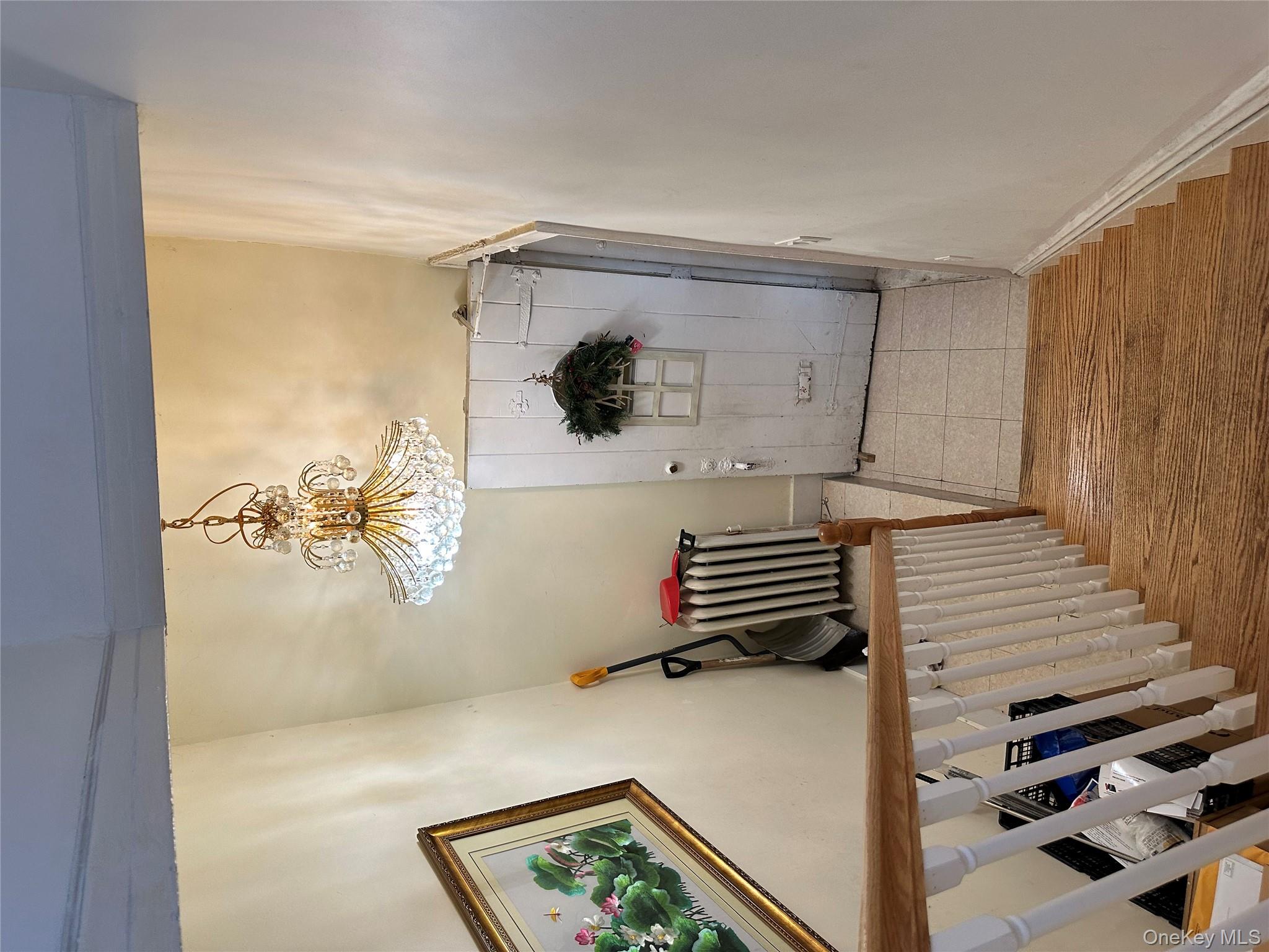 77-02 164th Street, Unit 2 Queens, NY 11366 - Photo 5 of 17 a view of a hallway with wooden floor and staircase