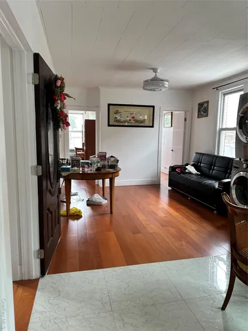 a living room with furniture flat screen tv and a window