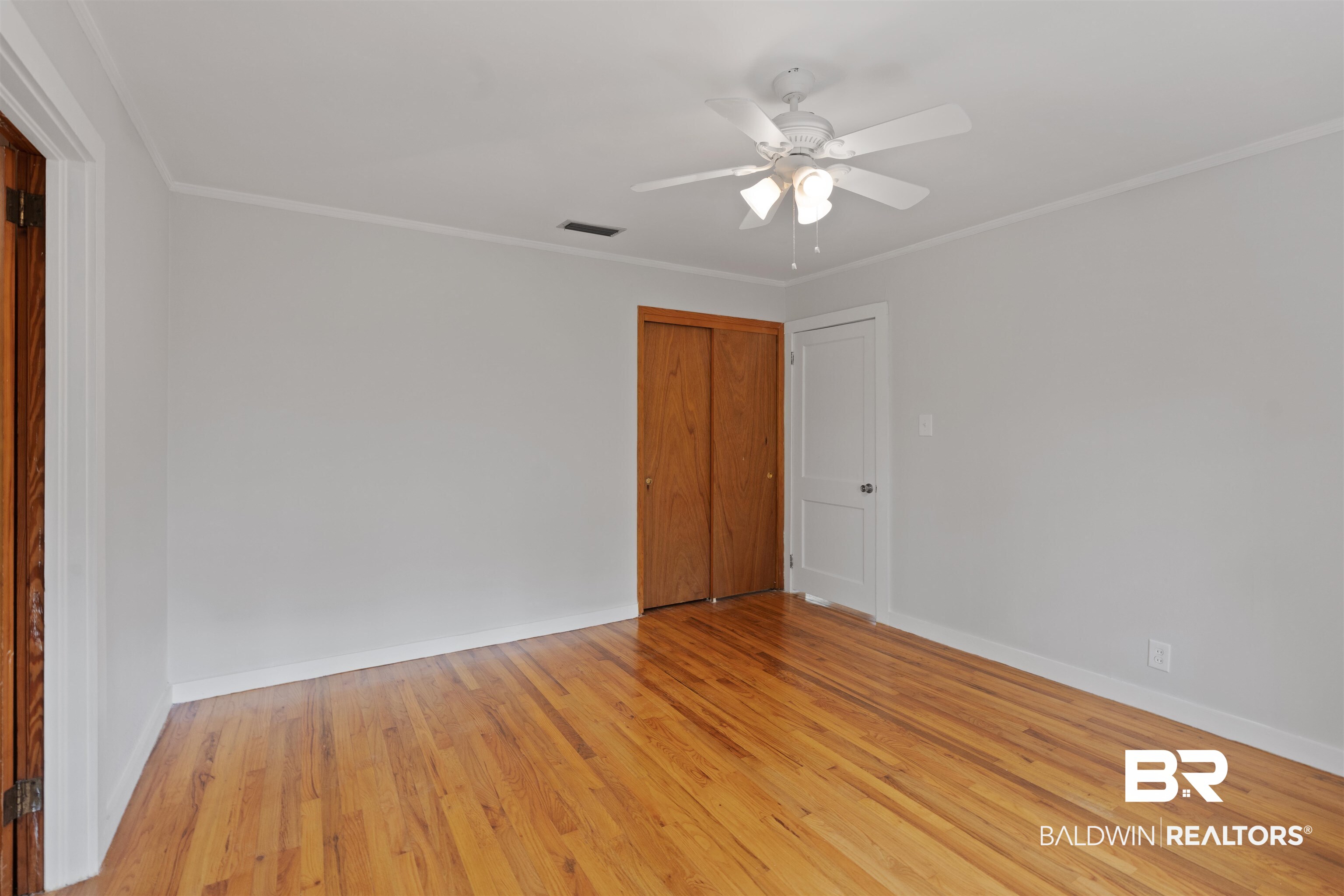 2126 Barron Place Mobile, AL 36605 - Photo 15 of 33 Empty room featuring light hardwood / wood-style flooring, ceiling fan, and crown molding