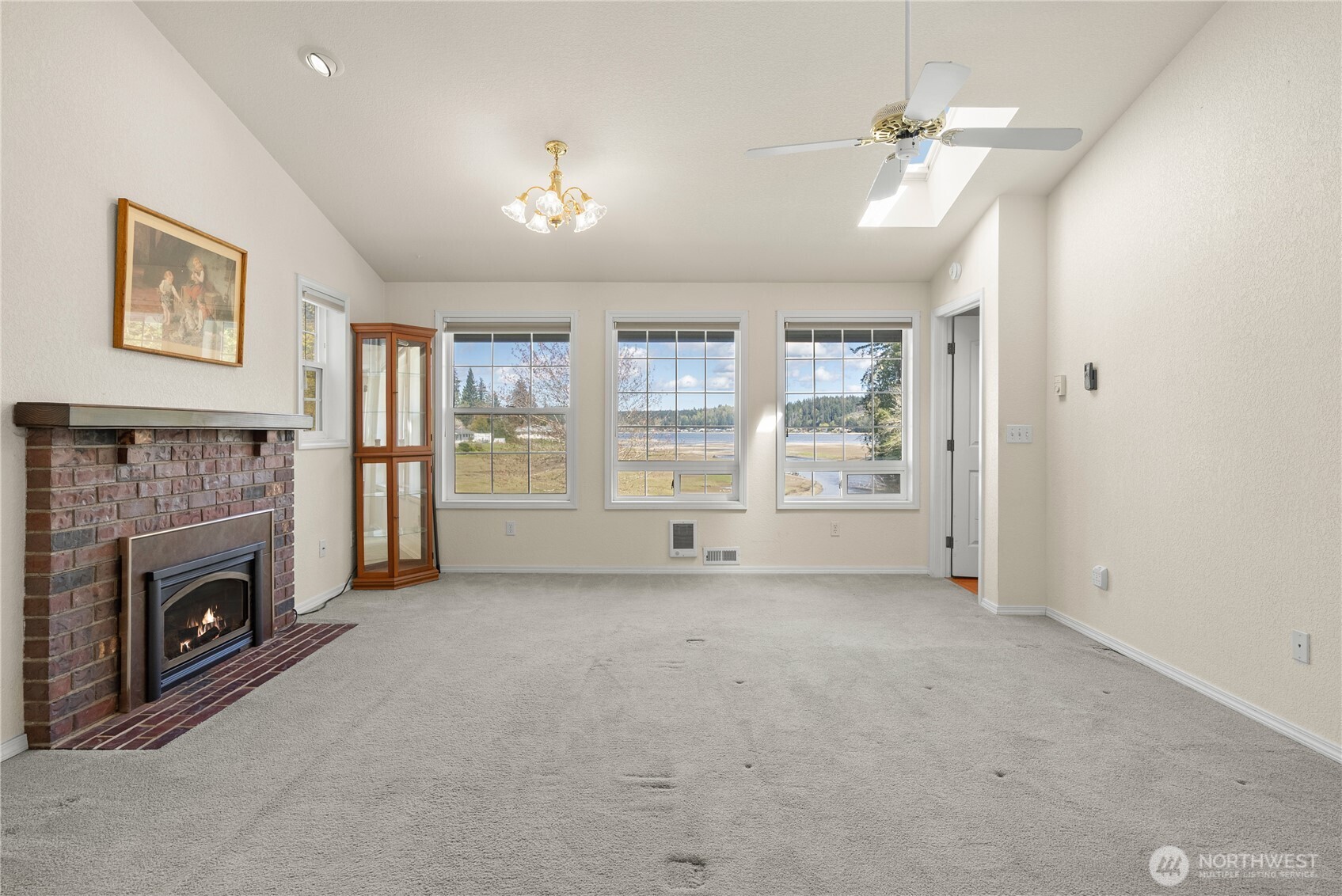 8320 East Grapeview Loop Road Allyn, WA 98524 - Photo 18 of 38 a view of an empty room with a fireplace and a window