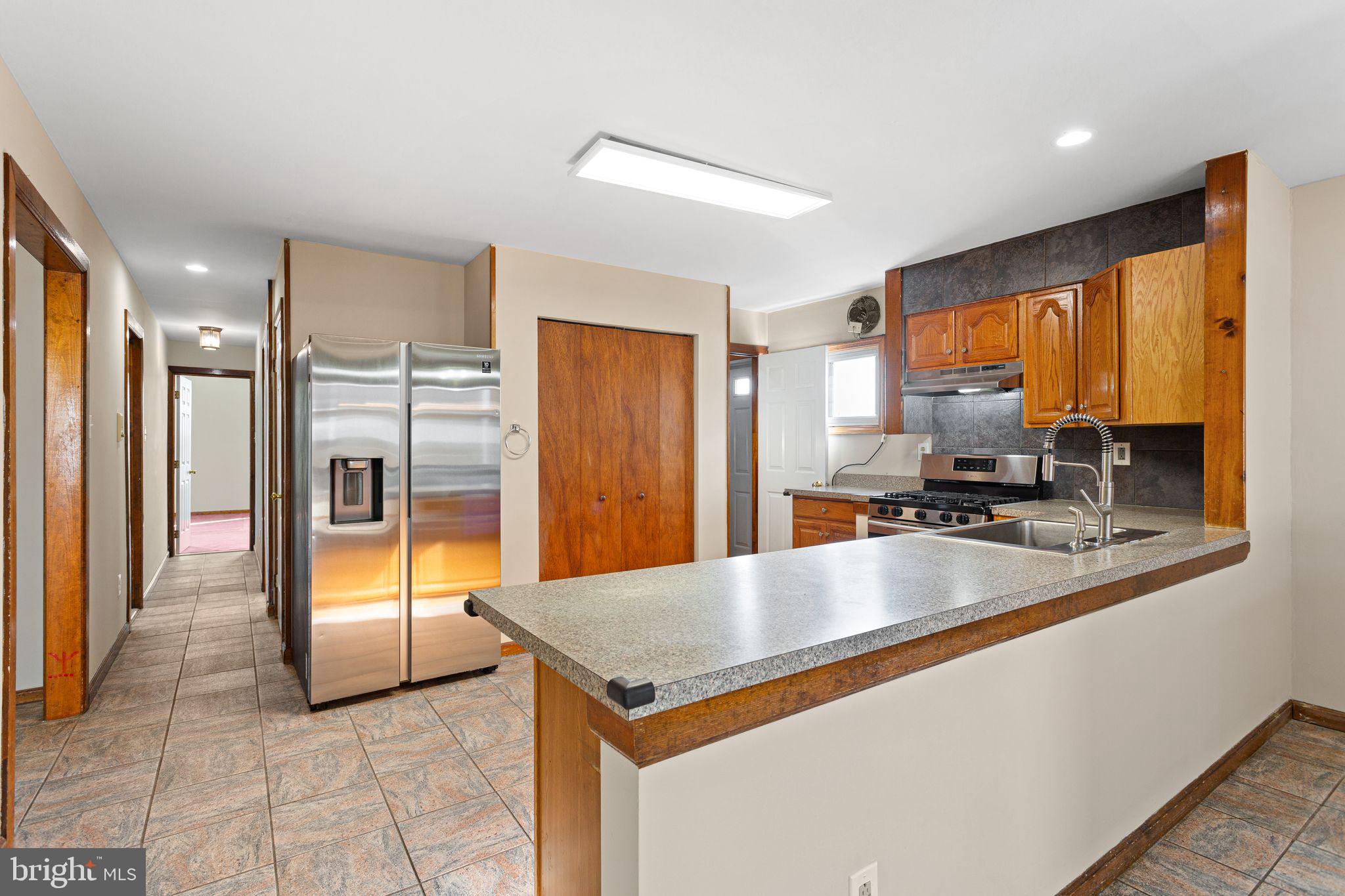2623 Knights Road Bensalem, PA 19020 - Photo 13 of 50 a kitchen with stainless steel appliances granite countertop a refrigerator a sink and a stove
