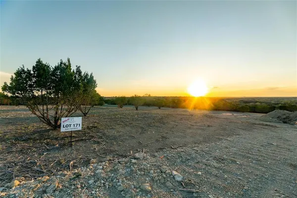 a view of a dry yard with mountain view
