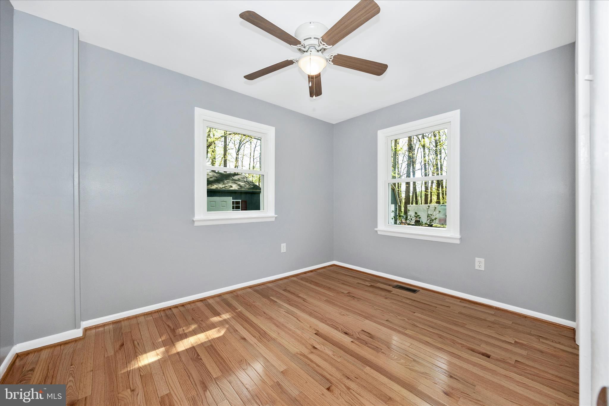 6518 Woodville Road Mount Airy, MD 21771 - Photo 18 of 53 a view of an empty room with wooden floor and a window