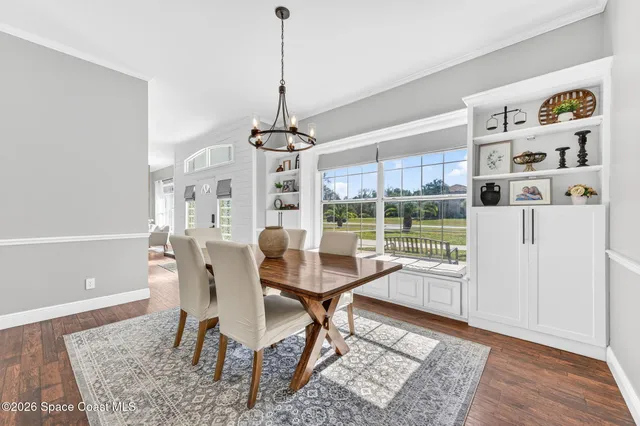 a living room with furniture and a clock