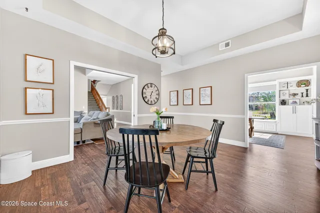 a living room with furniture a flat screen tv and a table