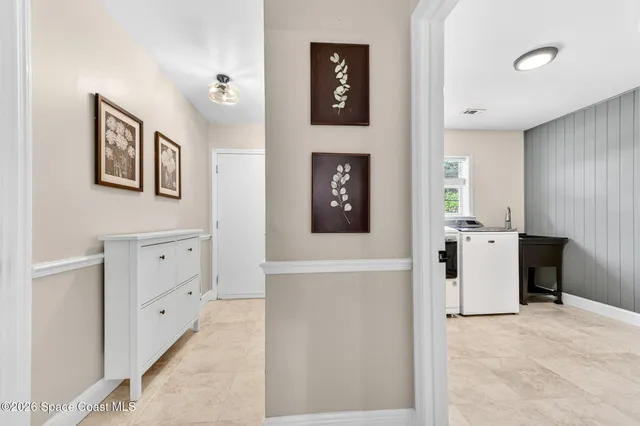 a dining room with furniture and a flat screen tv