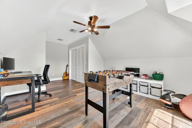 an aerial view of a house with a yard and swimming pool