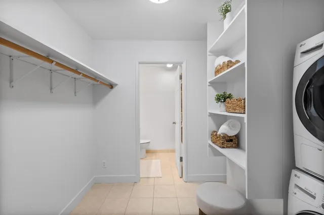 a view of walk in closet with clothes and shoes