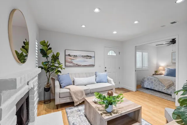 a living room with furniture and a potted plant