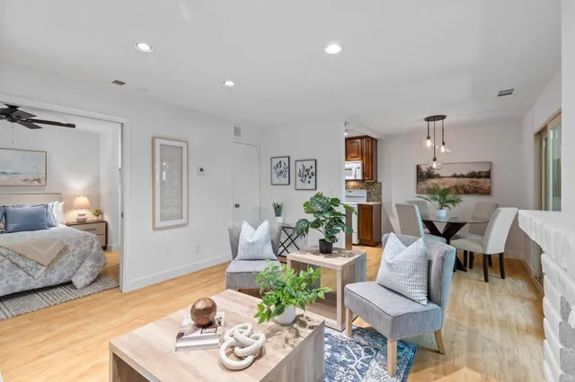 a living room with furniture and wooden floor
