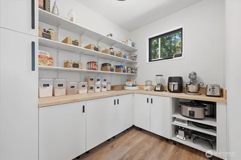 a kitchen with cabinets and wooden floor