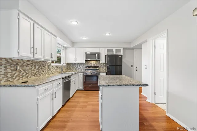 a kitchen with a sink cabinets and window