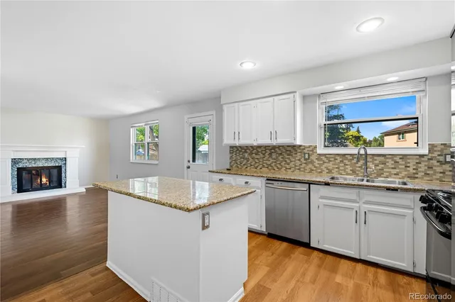 a bathroom with a granite countertop sink toilet and a mirror