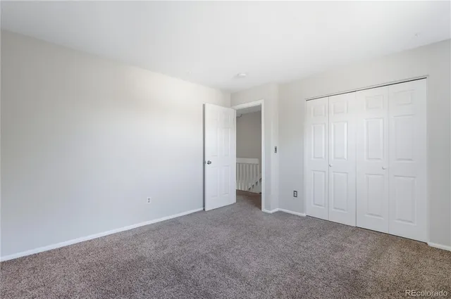a bathroom with a granite countertop toilet sink shower and mirror