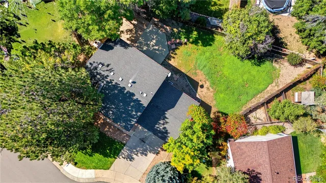 an aerial view of a house with a yard and garden