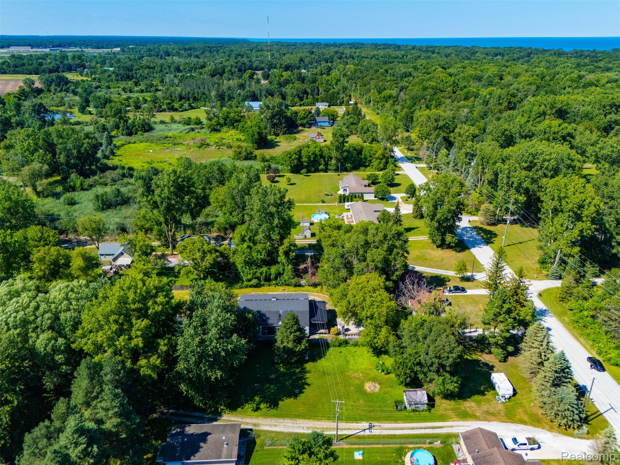 5161 Parker Road Fort Gratiot, MI 48059 - Photo 60 of 64 Expansive residential area featuring lush green tree coverage, paved roads, and scattered properties