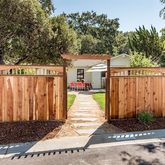 a view of a pathway with a wrought fence
