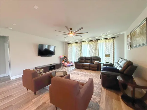 a view of a livingroom with furniture and a flat screen tv
