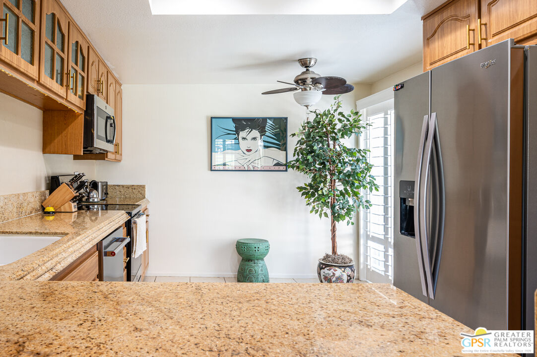 6000 East Driver Road Palm Springs, CA 92264 - Photo 12 of 40 a view of a kitchen with a sink and refrigerator