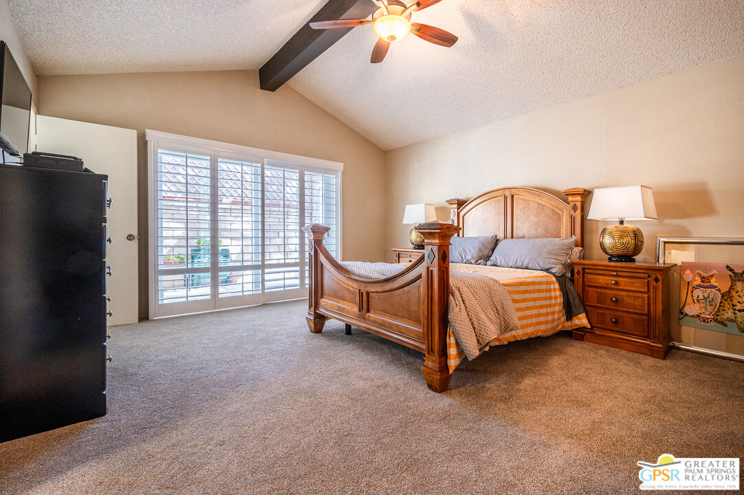 6000 East Driver Road Palm Springs, CA 92264 - Photo 26 of 40 a spacious bedroom with a bed and a large window