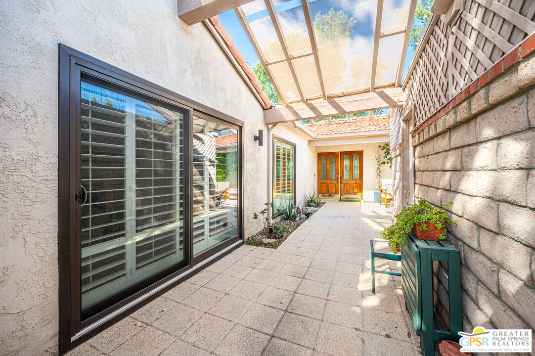 6000 East Driver Road Palm Springs, CA 92264 - Photo 8 of 40 a view of a house with a large window and potted plants